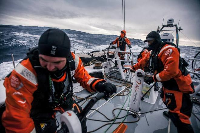 Onboard Team Alvimedica - Ryan Houston driving in strong winds and Southern Ocean waves, while Charlie Enright (L) and Dave Swete (R) shake a reef on the mainsail - Volvo Ocean Race 2015 ©  Amory Ross / Team Alvimedica